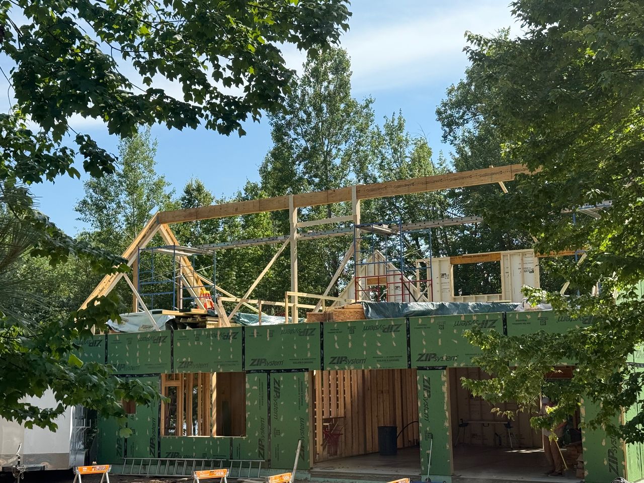 Custom home under construction with ZIP System sheathing and gable roof framing on a ProCon job site near Duluth, Minnesota