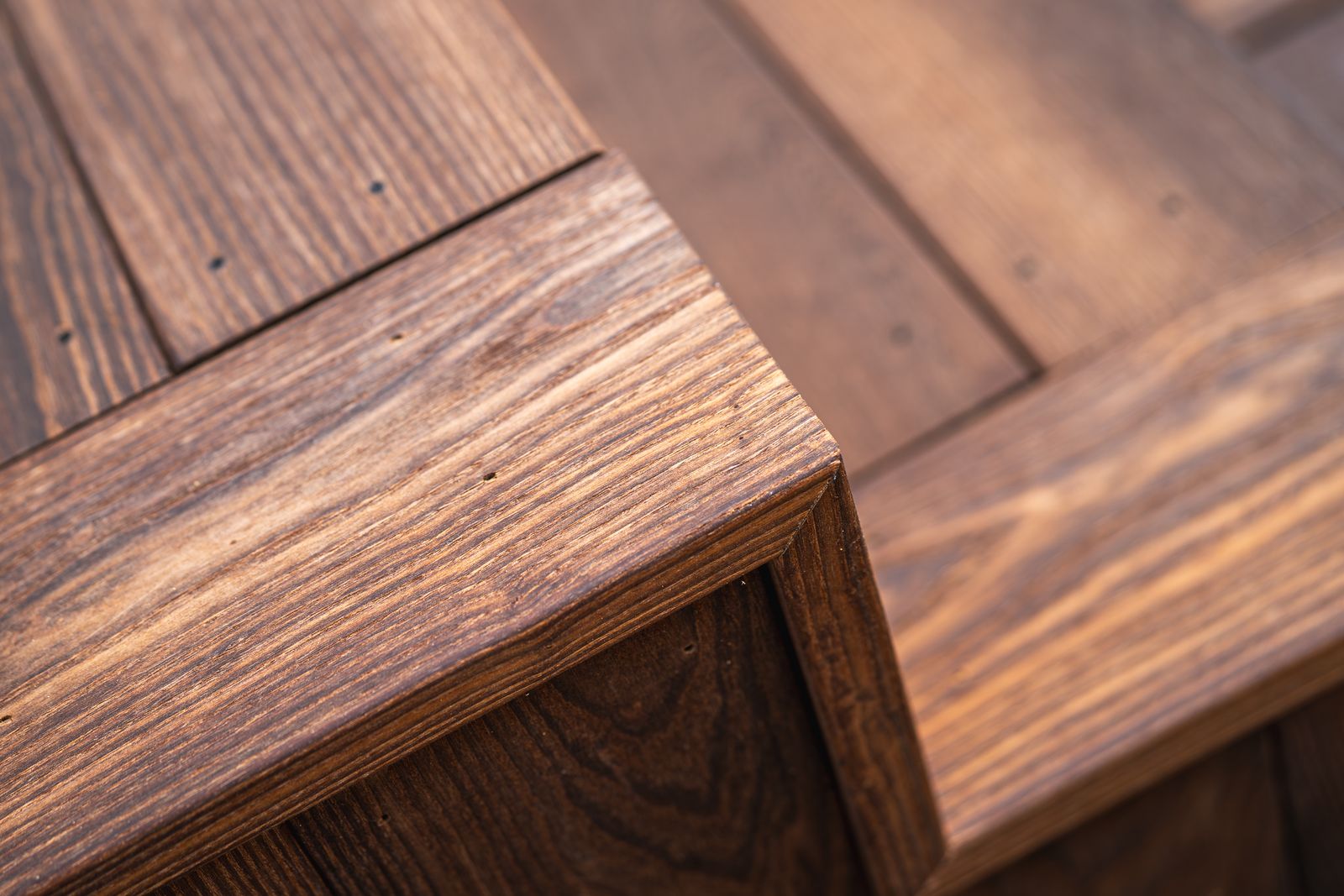 Close-up of a mitered thermally modified wood deck corner showing tight joinery