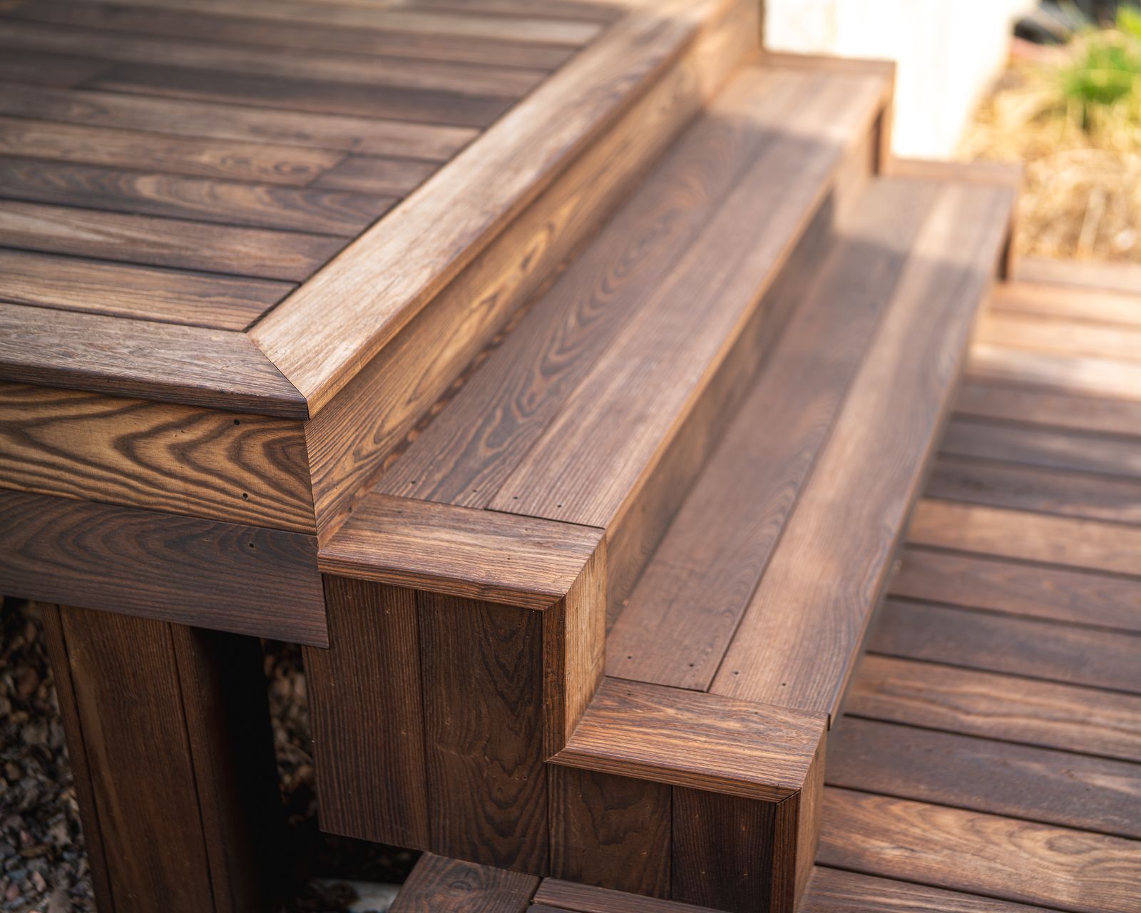 Cascading thermally modified wood deck steps at the Island Lake home